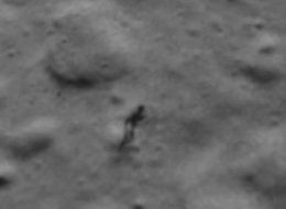 black and white image of what vaguely resembles a humanoid figure on the surface of the moon