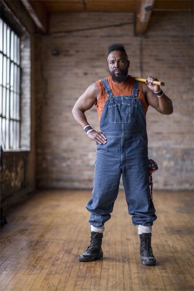 image of Mr. T, a middle-aged black man with a mohawk, wearing overalls and black boots, and balancing a sledgehammer over his shoulder