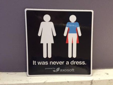 image a women's bathroom symbol, in which the dress is revealed to be a superhero cape