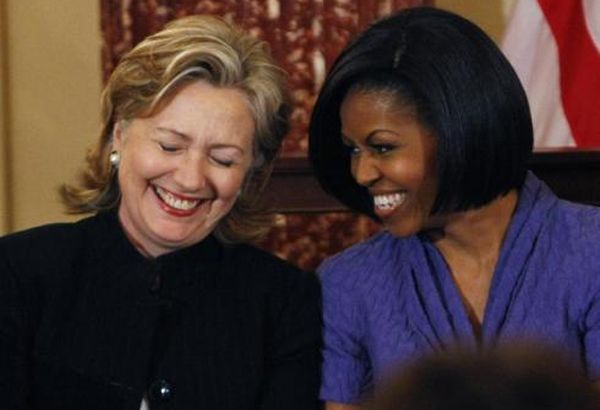 image of Hillary Clinton and First Lady Michelle Obama, a thin black woman, sitting beside each other, laughing