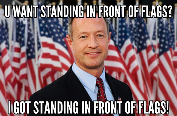 image of Martin O'Malley standing in front of a bunch of US flags, to which I've added text reading: 'U want standing in front of flags? I got standing in front of flags!'