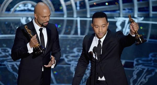 image of rapper Common and singer John Legend, both black men, holding their Oscars after winning Best Song for 'Glory' from 'Selma'