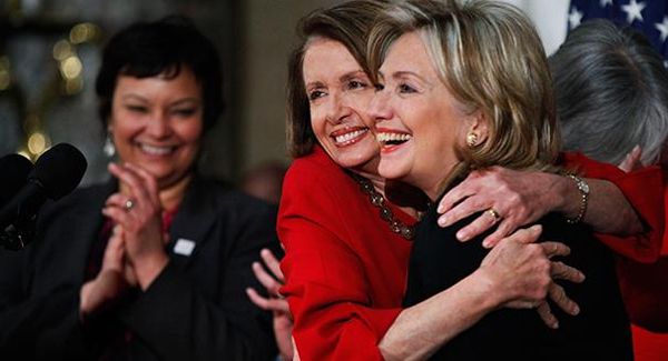 image of Hillary Clinton and Nancy Pelosi, a thin white woman, hugging each other tightly and smiling