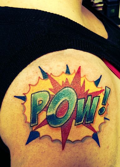 image of my upper right arm, featuring a comic-style POW! tattoo in vivid colors