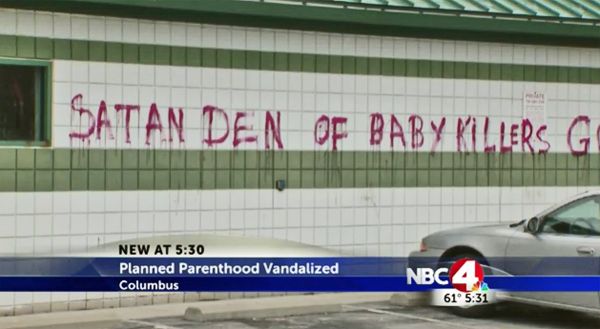 image of the Planned Parenthood building in Columbus, with 'Satan Den of Baby Killers' painted across the front in huge red letters