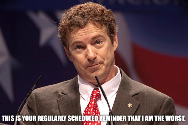 image of Rand Paul standing in front of a US flag, to which I've added text reading: 'This is your regularly scheduled reminder that I am the worst.'