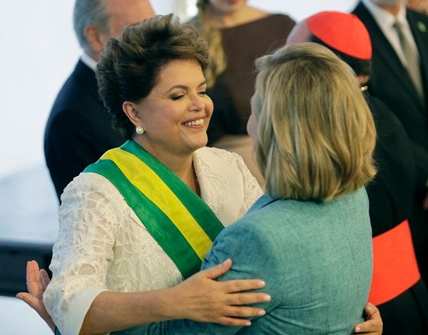 image of Hillary Clinton with Brazilian President Dilma Rousseff, an in-betweenie Brazilian woman; they are greeting each other with a hug