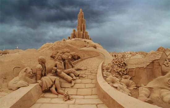image of a sand sculpture of Dorothy and her traveling companions from the Wizard of Oz, resting on the side of the Yellow Brick Road on the way to the Emerald City