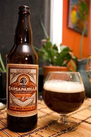 image of a bottle of sarsaparilla sitting beside a filled glass