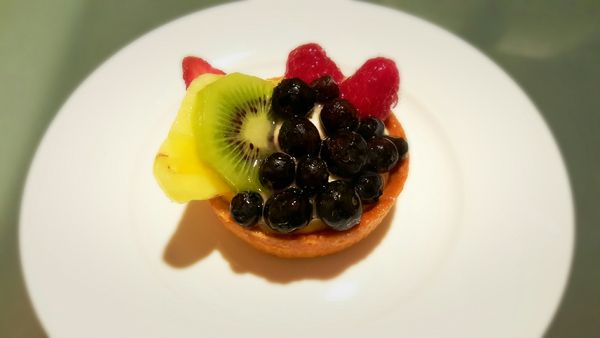 image of a small fruit tart sitting on a white plate