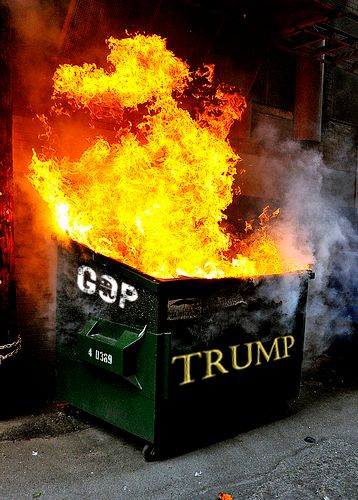 image of a dumpster on fire, which has a fading GOP logo on the side and a giant gold TRUMP on the front