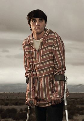image of actor RJ Mitte, a thin young white man with cerebral palsy who is pictured with wrist-gripped crutches, playing Walt Jr. on Breaking Bad