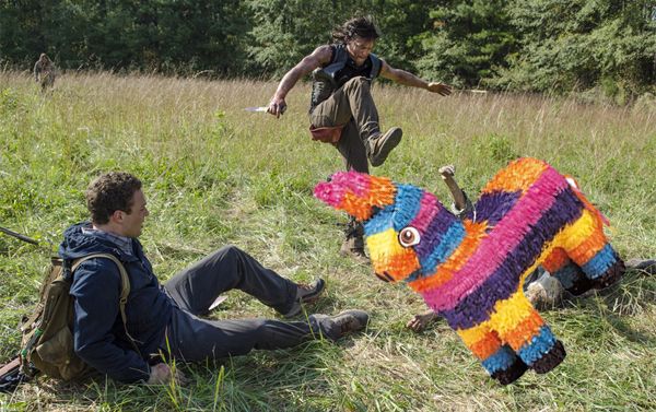 image from the latest episode of The Walking Dead, showing Daryl about to stomp on a zombie which I have replaced with a piñata