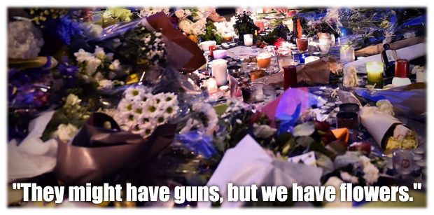 image of the Paris memorial, to which I've added text reading 'They might have guns, but we have flowers.'