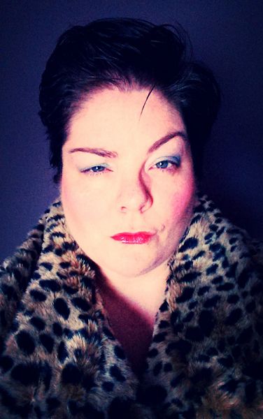 image of me with my hair punked up, wearing colorful make-up and a leopard print coat