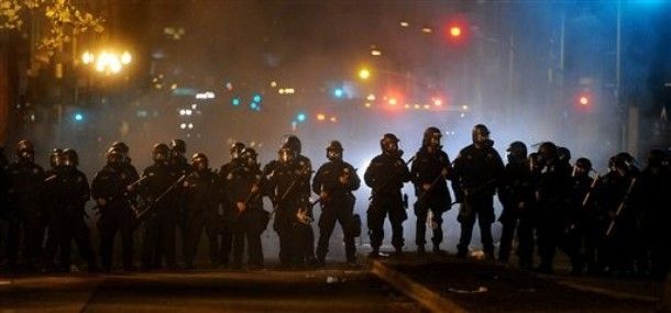image of police in riot gear at night in Oakland