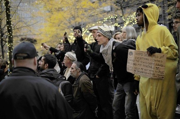 image of a crowd of protesters at Zuccotti Park witnessing and documenting an arrest