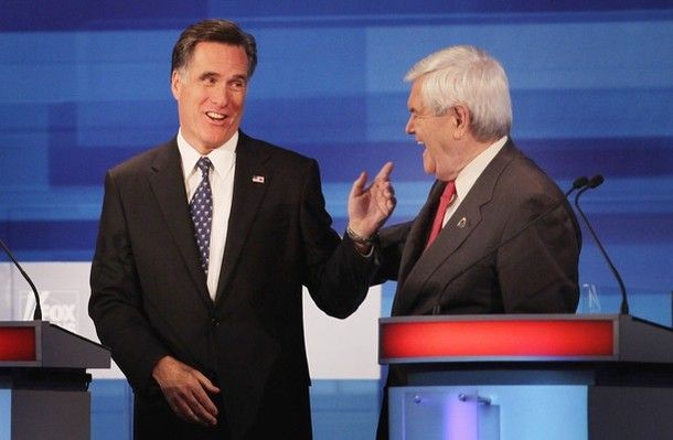 image of Mitt Romney talking to Newt Gingrich at the debate