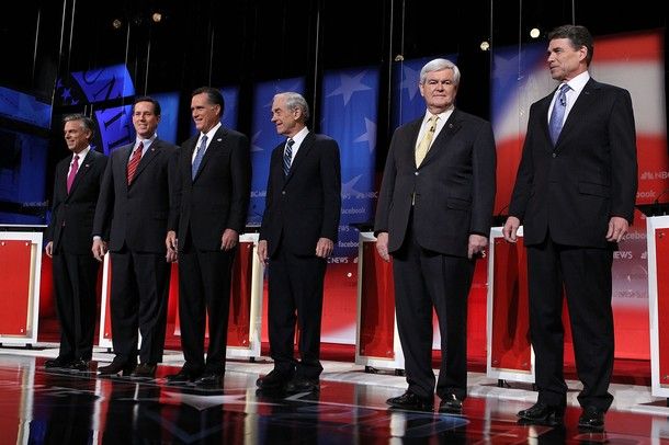 the six candidates stand at podiums during Sunday morning's debate in New Hampshire