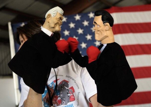 image of white woman holding Newt Gingrich and Mitt Romney boxing puppets