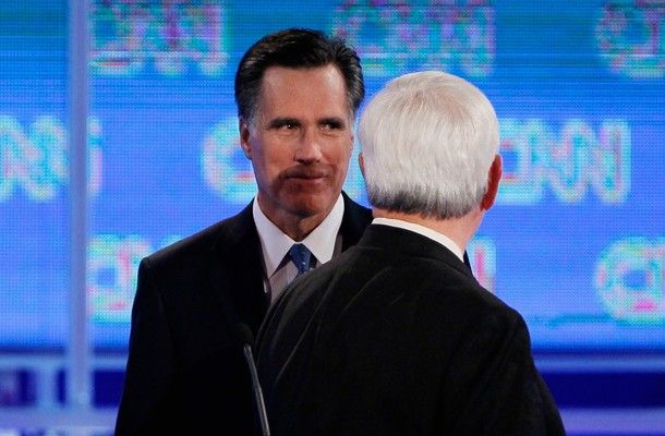 Mitt Romney grins menacingly at Newt Gingrich