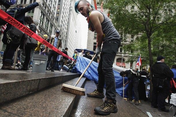image of young male protester cleaning stairs near Zuccotti Park