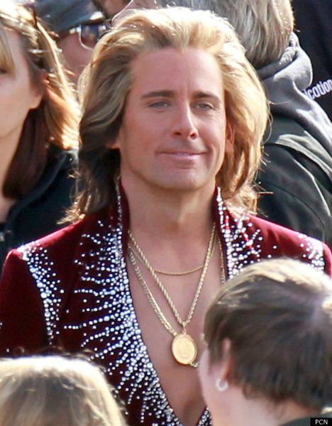 image of Steve Carell dressed as an old-school Las Vegas magician, complete with bedazzled burgundy jumpsuit, gold chains, and flowing blond hair