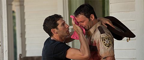 image of Shane wiping Grimes' face with a rag