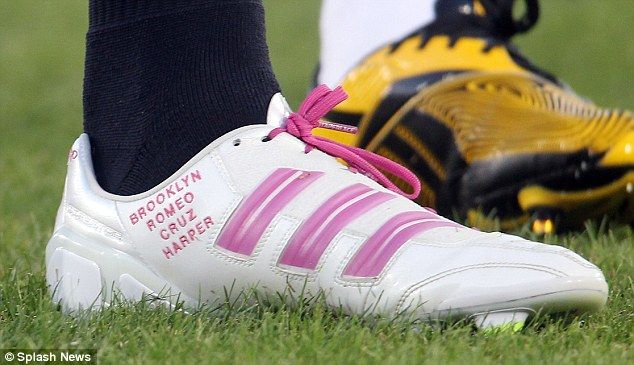 image of professional footballer David Beckham's game boot, with the names of his children, including his new baby daughter, stitched into the side in pink, and tied with pink laces