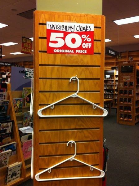 image from a retail store showing empty hangers with a sign above reading 'invisibility cloaks 50% off original price'