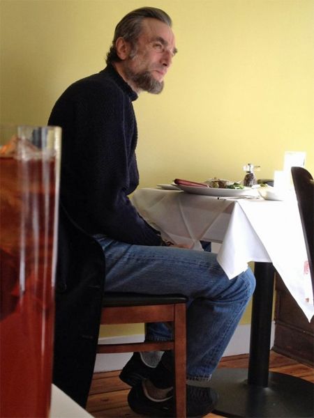 Daniel Day-Lewis sitting in a cafe in Lincoln hair and make-up