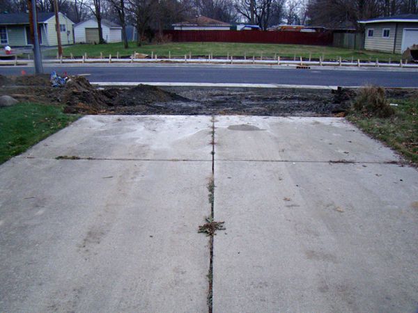 image of my driveway with a huge dirt pit where the bottom of my driveway used to be