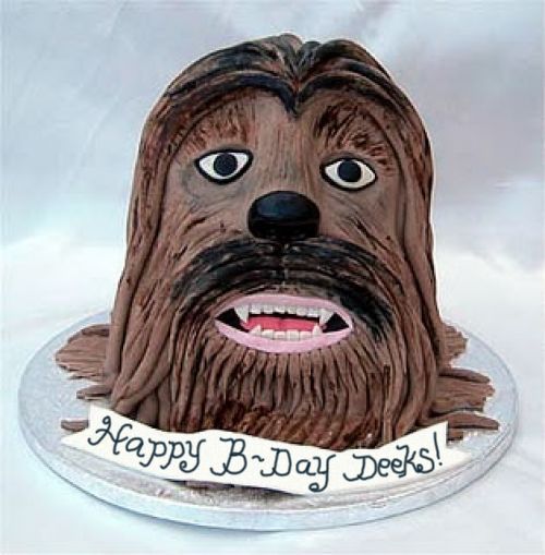 Deeky's birthday cake, which is a Chewbacca head with a banner reading 'Happy B-Day Deeks!'