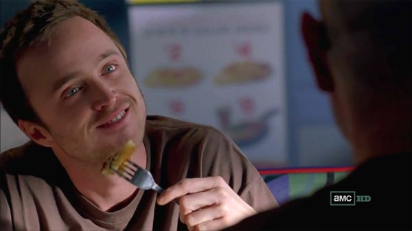 screen cap from Breaking Bad featuring Jesse eating pancakes and grinning