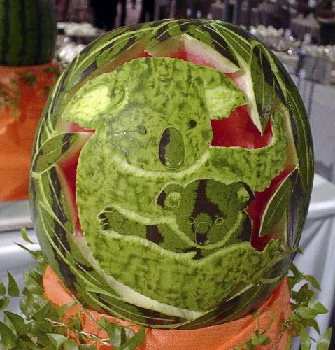 image of a watermelon carved into the shape of mama koala holding baby koala
