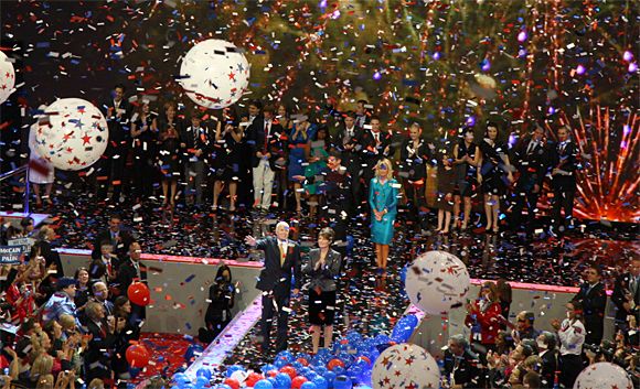 image from 2008 GOP Convention of John McCain and Sarah Palin taking the stage to confetti, balloons, lights, fireworks, and all kinds of general madcap celebration