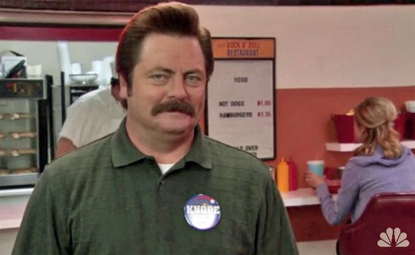 an image of Ron Swanson standing in front of a bowling alley restaurant called the Rock n' Roll Restaurant, selling nothing but hotdogs and hamburgers, for a dollar and a dollar thirty-five, respectively
