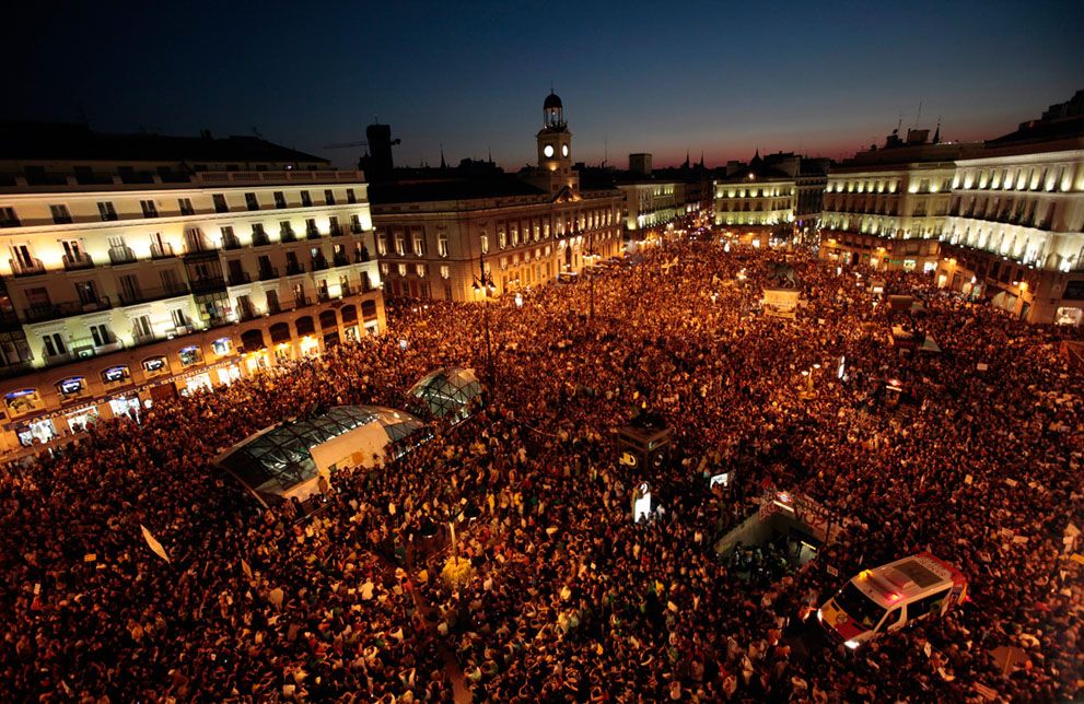 image of rallying crowd filling a public square at nighttime