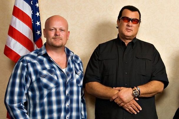 an image of Joe the Plumber standing next to Steven Seagal and an American flag