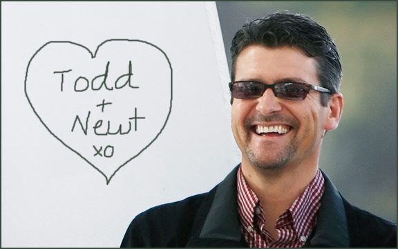 Todd Palin wearing sunglasses next to a heart-shaped drawing reading 'Todd + Newt xo'