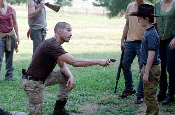 image of Shane handing a handgun to Carl