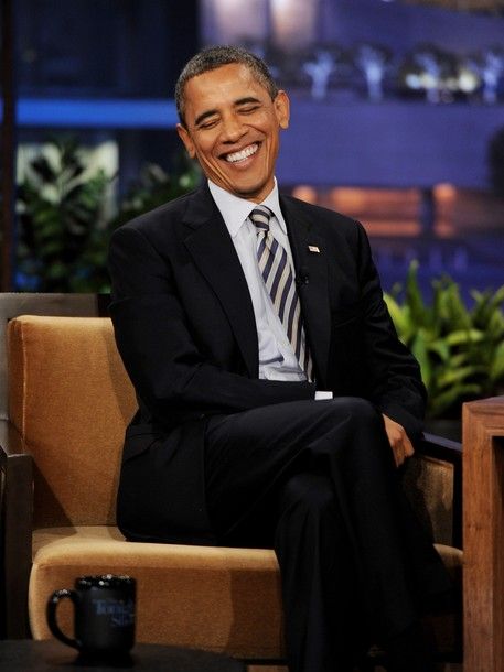 image of President Obama in the guest chair at The Tonight Show, laughing