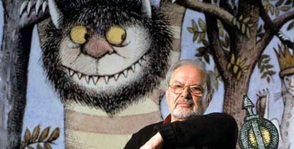 Sendak sitting in front of an image of one of his characters from WTWTA