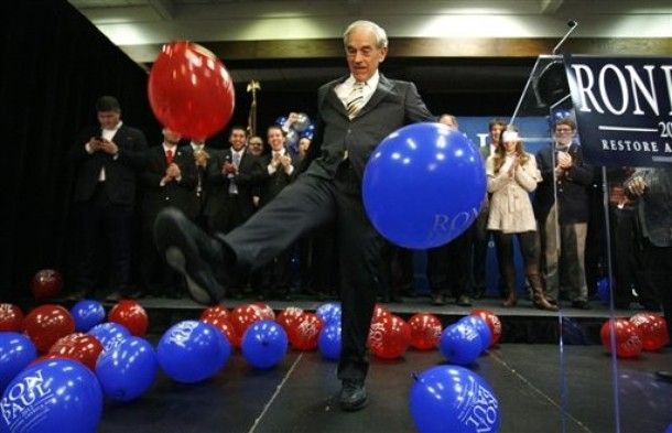 Ron Paul kicks red and blue balloons onstage