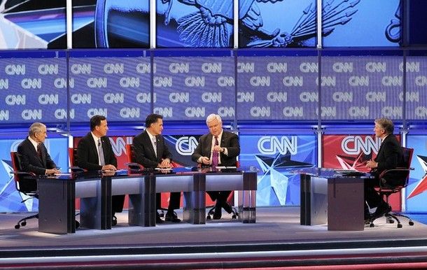 image of four GOP candidates on a stage with moderator John King, surrounded by about 87,000 CNN logos