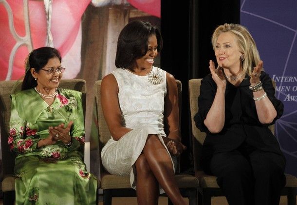 Michelle Obama looks at Hillary Clinton with a smile