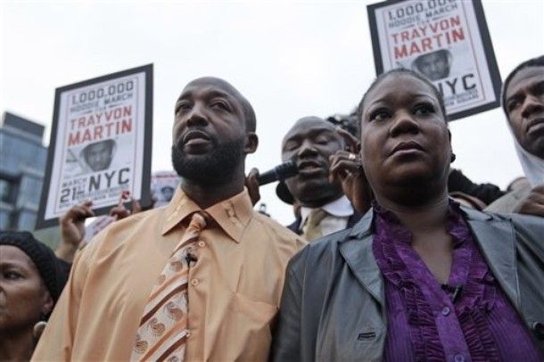 image of a black man and a black woman walking in the middle of other demonstrators