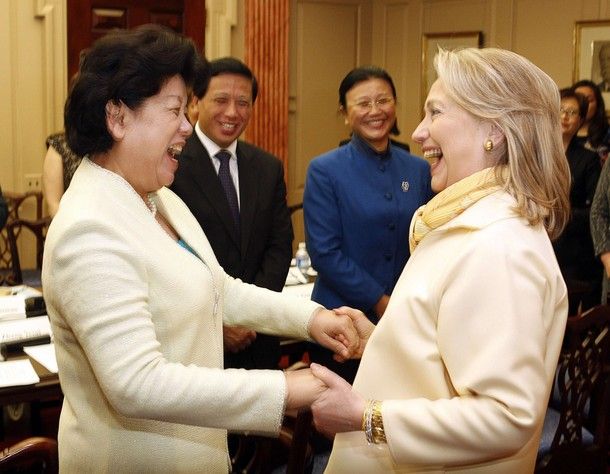 image of Chen Zhili, Vice Chairwoman of the Standing Committee of China's National People's Congress, and Secretary of State Hillary Clinton greeting one another with clasped hands and big grins