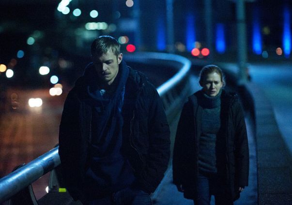 image of Mireille Enos as Det. Sarah Linden and Joel Kinnaman as Det. Stephen Holder walking along an overpass at night from the latest episode of The Killing