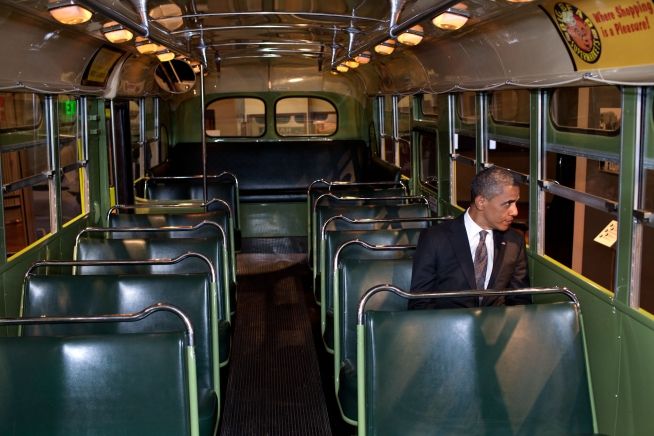 image of President Barack Obama sitting on an otherwise empty bus, looking out the window